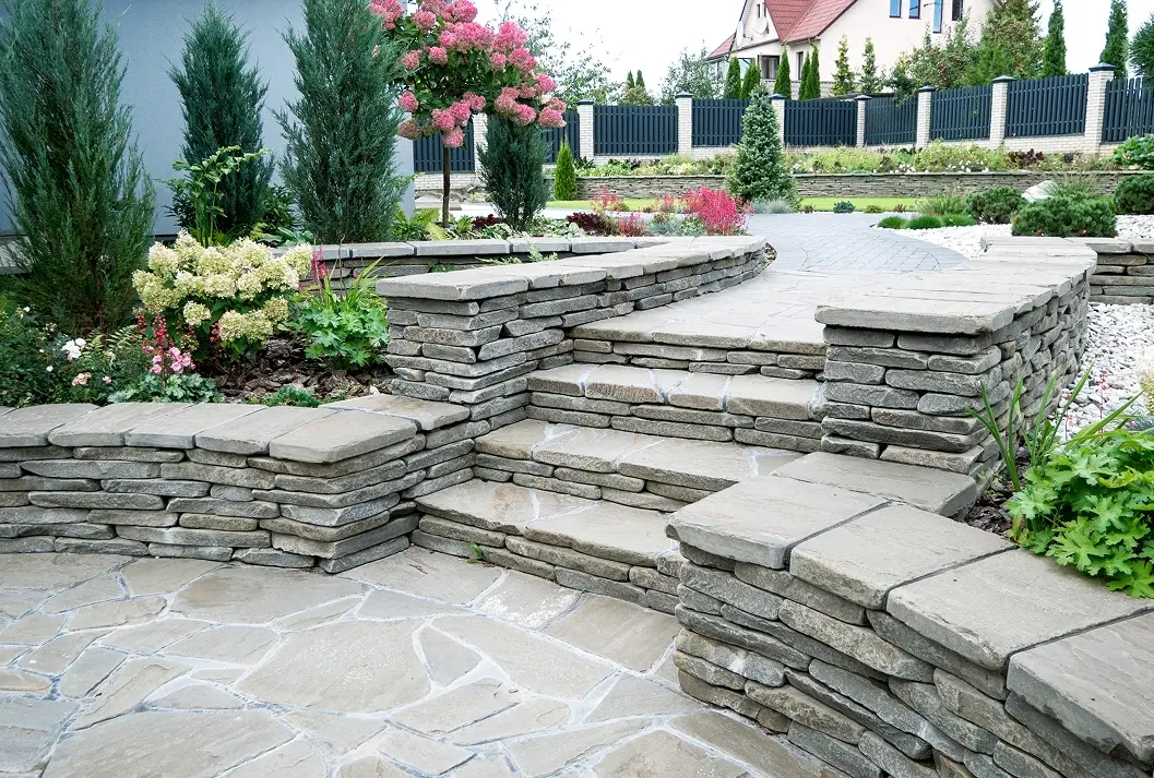 Natural stone steps and retaining walls in a landscaped garden.